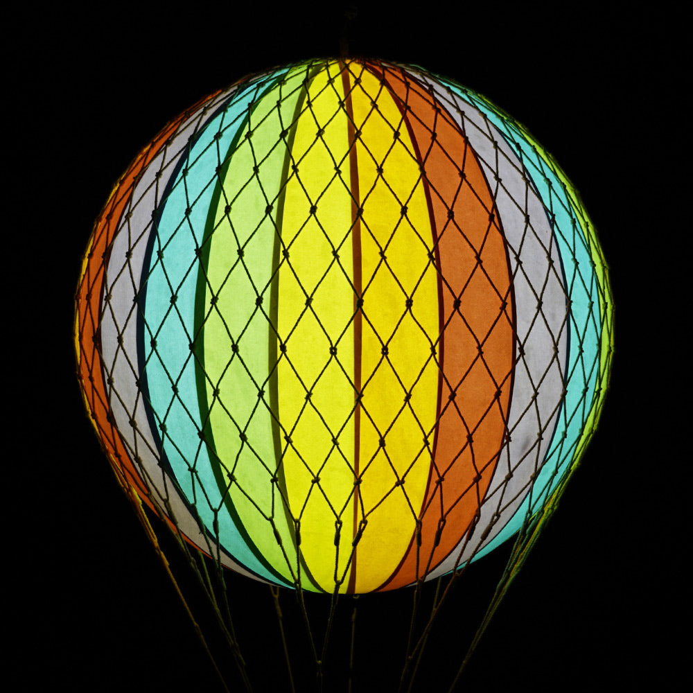 A szivárványszínűl LED-es hőlégballon sötétben.