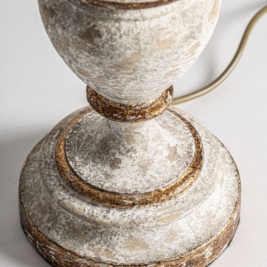 Close up of a weathered white lamp base with gold accents from the Shabby Light collection