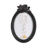 Fekete színű, ovális formájú fényképtartó.