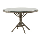 Üveglappal fedett, antikszürke színű, műrattan kerti asztal.