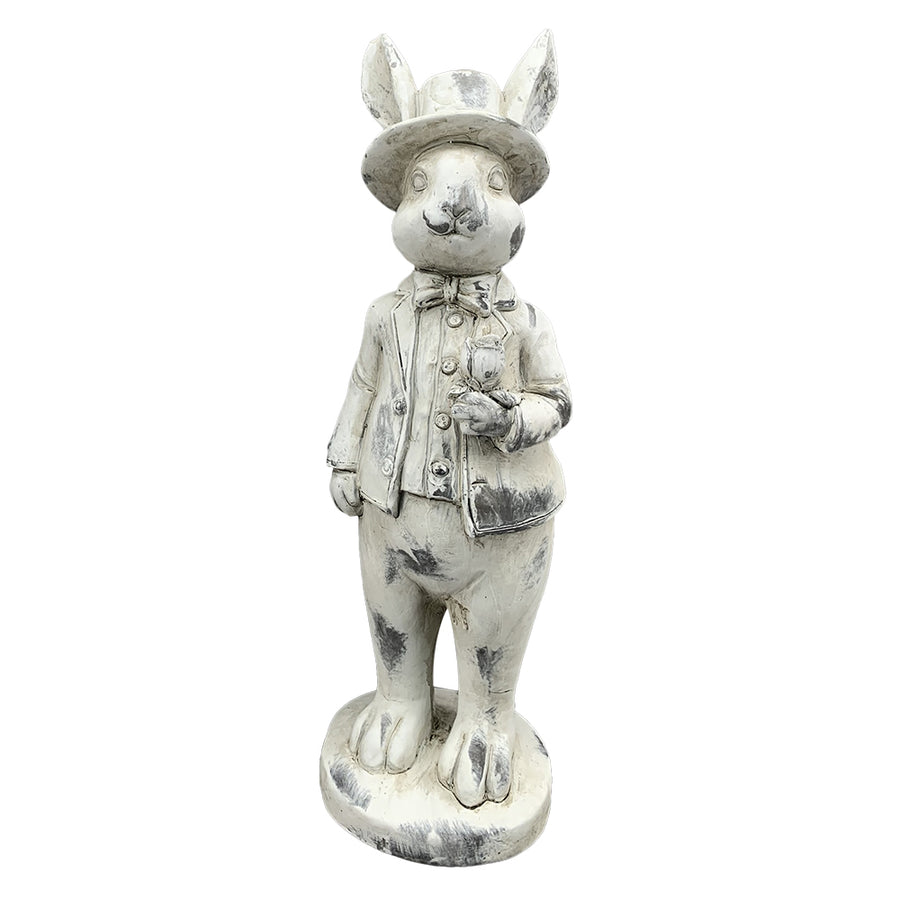 Antikolt felületű, krémszínű húsvéti nyuszifiú figura.