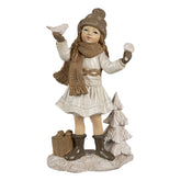 Tradicionális megjelenésű, madárkát tartó, bézs színű karácsonyi kislány.