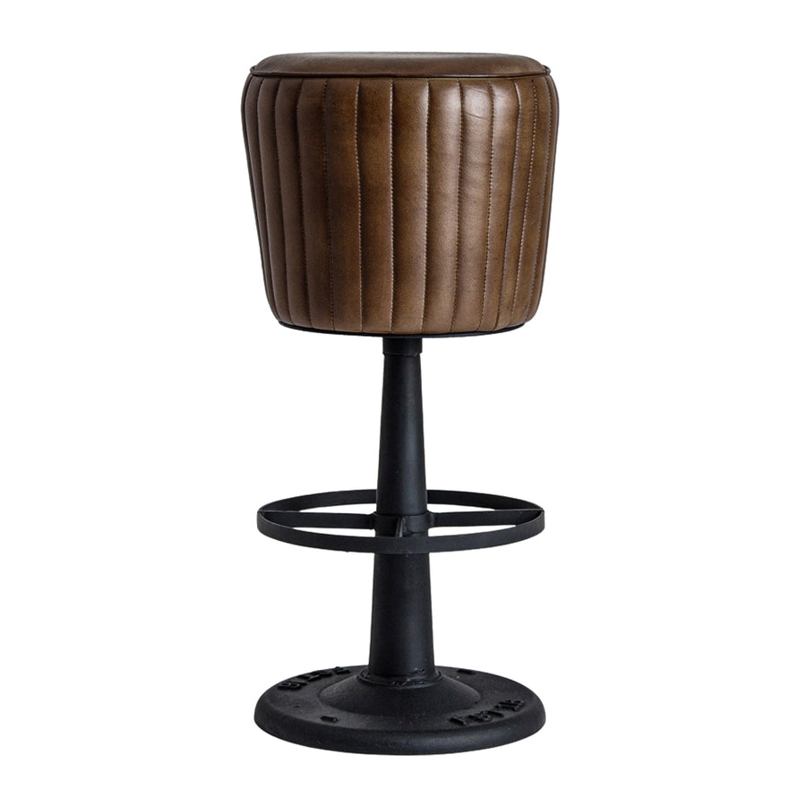 Loft style bar stool with brown leather vertical stitching and a black metal pedestal with round footrest