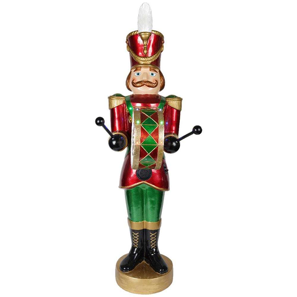 Piros és zöld színű, dobos karácsonyi diótörő figura.