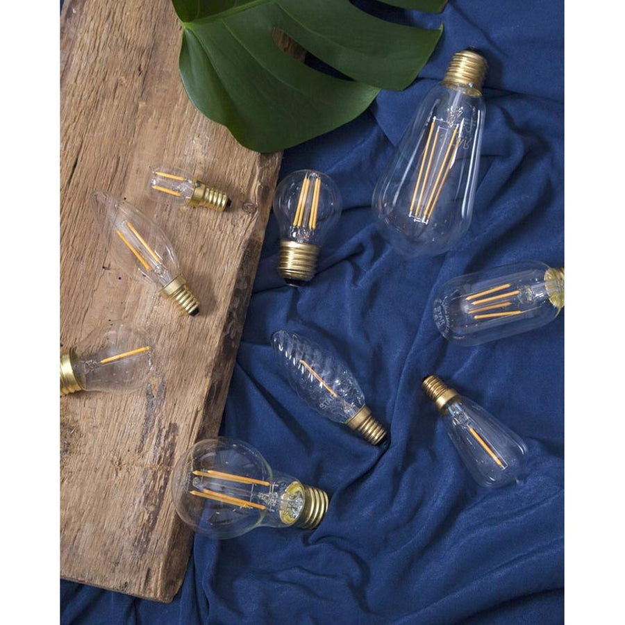 Gold chandelier with three Edison style LED filament bulbs on black sockets