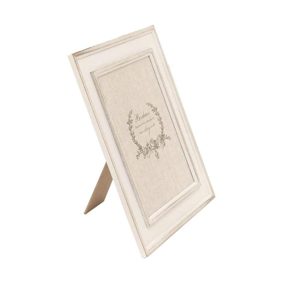 Cream white vintage tabletop photo frame shown at an angle on its easel stand