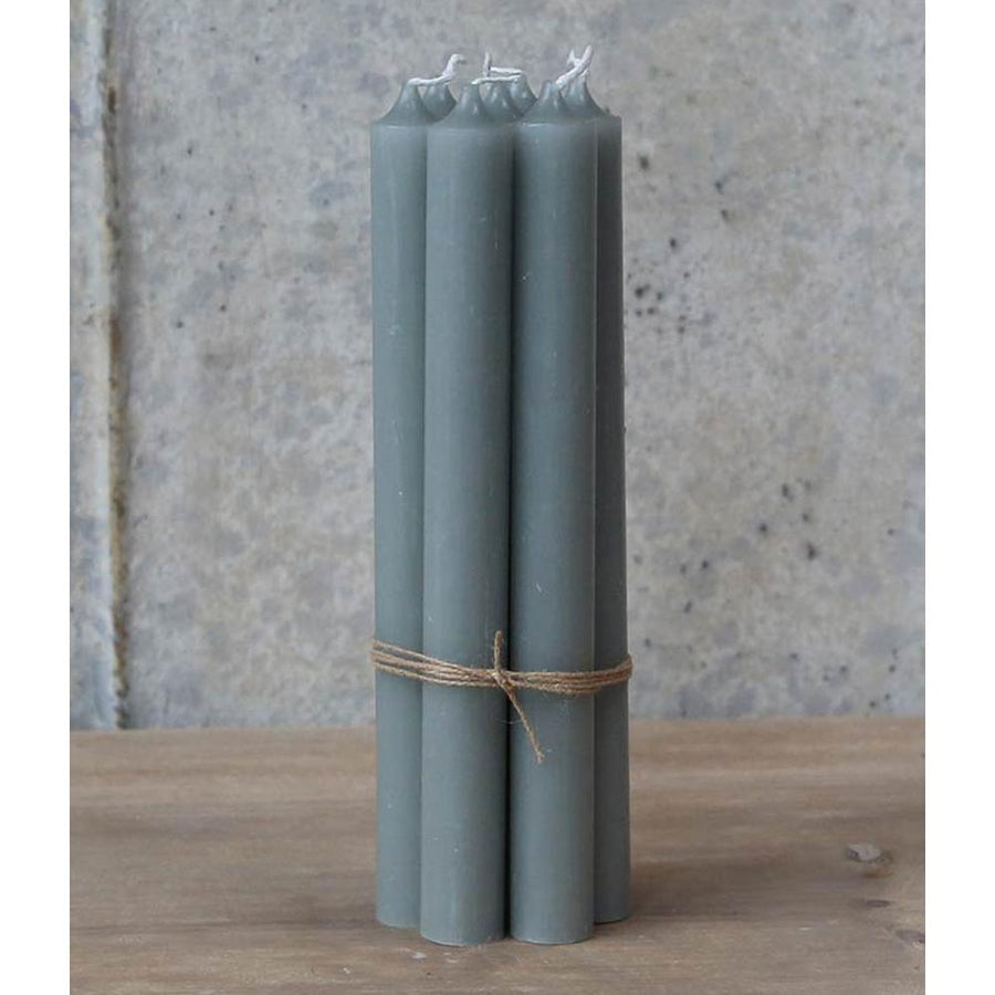 Four gray pillar candles tied with twine, displayed on a wooden surface