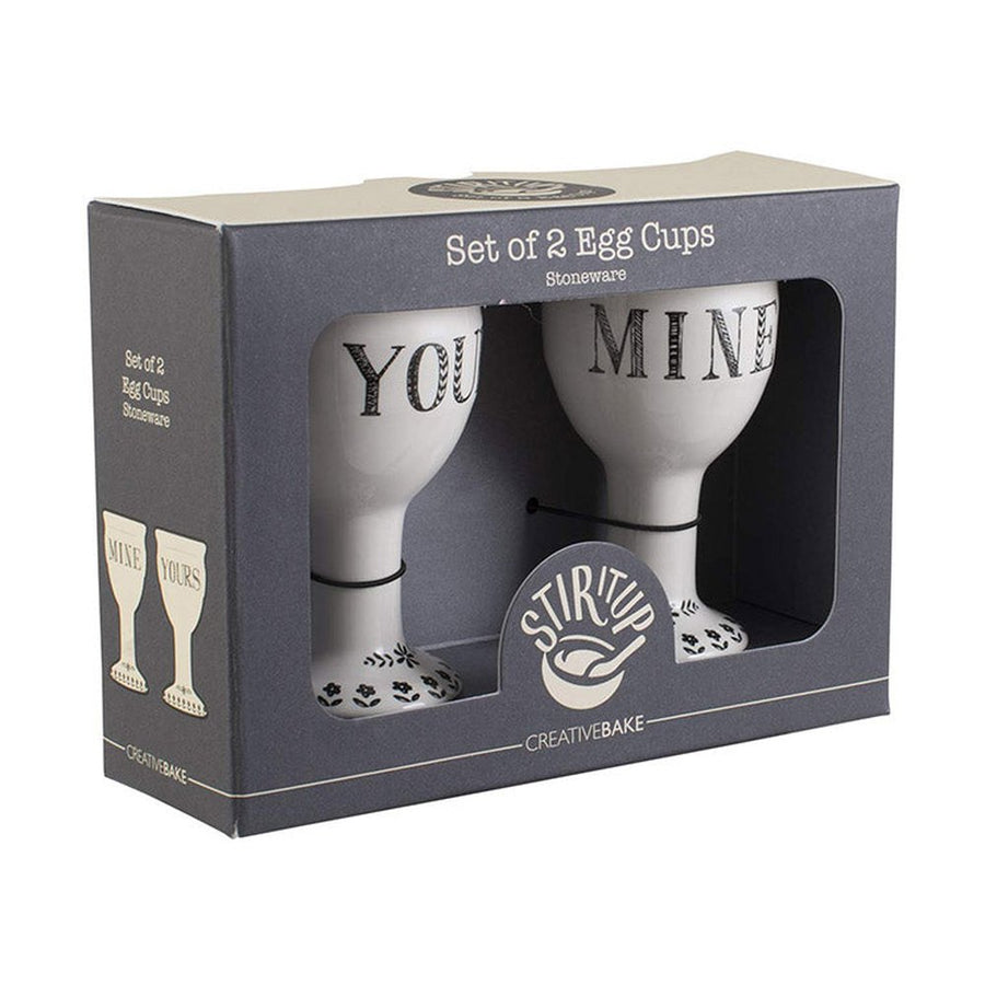 Boxed set of two white ceramic egg cups labeled YOU and MINE with floral patterned bases