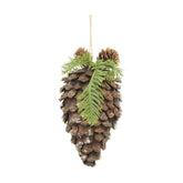 Fenyőággal és apró tobozokkal díszített, havas felületű, függeszthető karácsonyi toboz dísz.