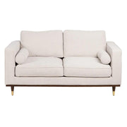 Bézs színű szövettel kárpitozott, 2 személyes kanapé.