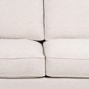 Bézs színű szövettel kárpitozott, 2 személyes kanapé.