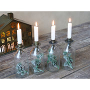 4 darabos, számozott díszítésű üvegpalackba kialakított adventi gyertyatartó szett.