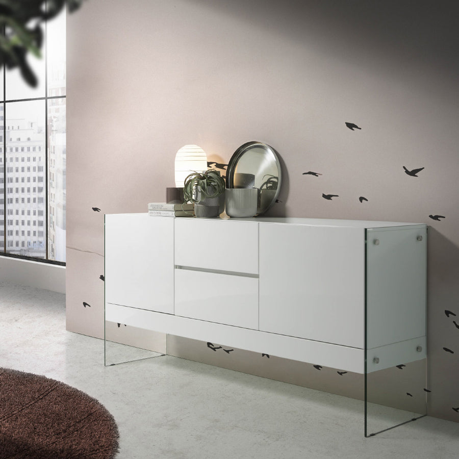 Kortárs stílusú,magasfényű, fehér lakkal festett, dizájn komódszekrény edzett üveg lábakkal.