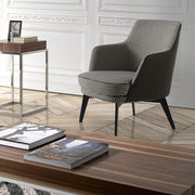 Kortárs stílusú, fekete színű műbőrrel és pepita színű szövettel kárpitozott dizájn fotel.