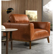 Kortárs stílusú, dohánybarna bőrrel kárpitozott, dizájn fotel diófa lábakkal.