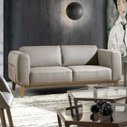 Kortárs, taupe színű bőrrel kárpitozott, diófa furnérral borított, dizájn kanapé.