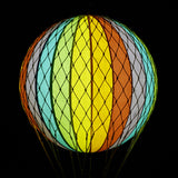 A szivárványszínűl LED-es hőlégballon sötétben.
