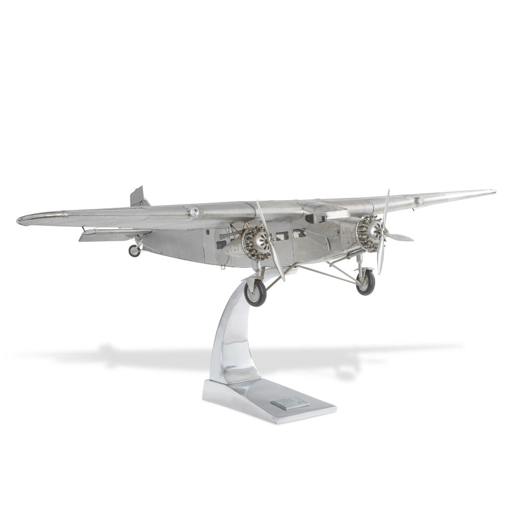 Fémből készült, részletgazdag, ezüstszínű Ford Trimotor repülőgép-modell állványon