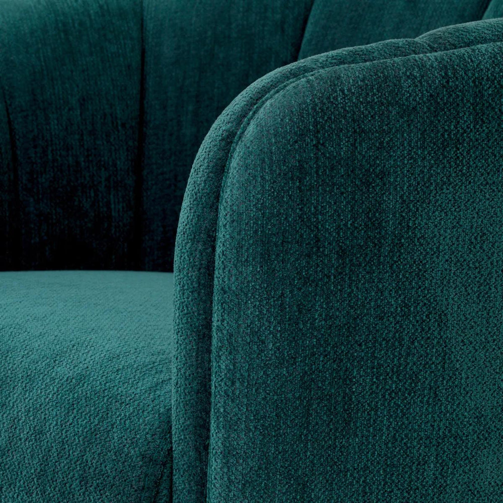 Tengerzöld színű szövettel kárpitozott dizájn fotel.