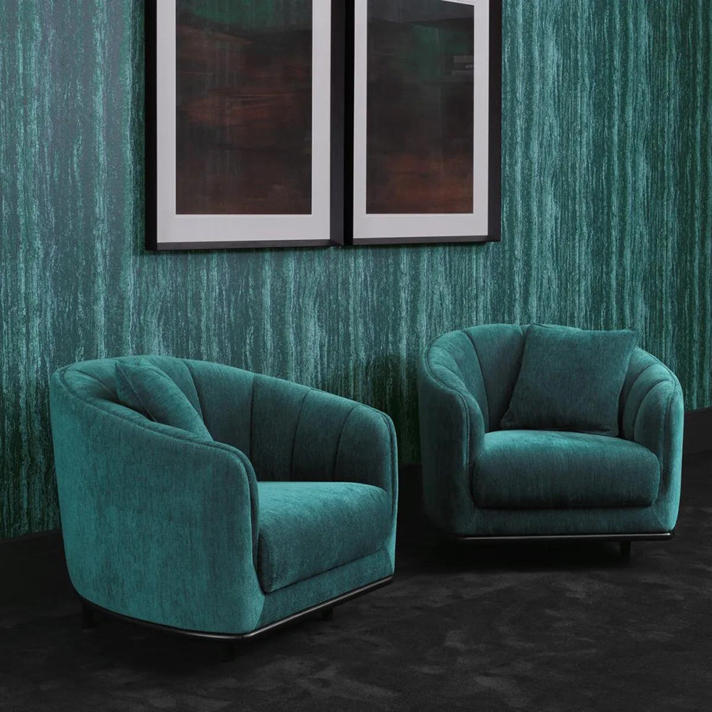 Tengerzöld színű szövettel kárpitozott dizájn fotel.