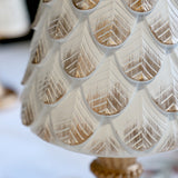 Közelkép az ANTIQUE antik krém dekor fenyő kúp díszített felületéről