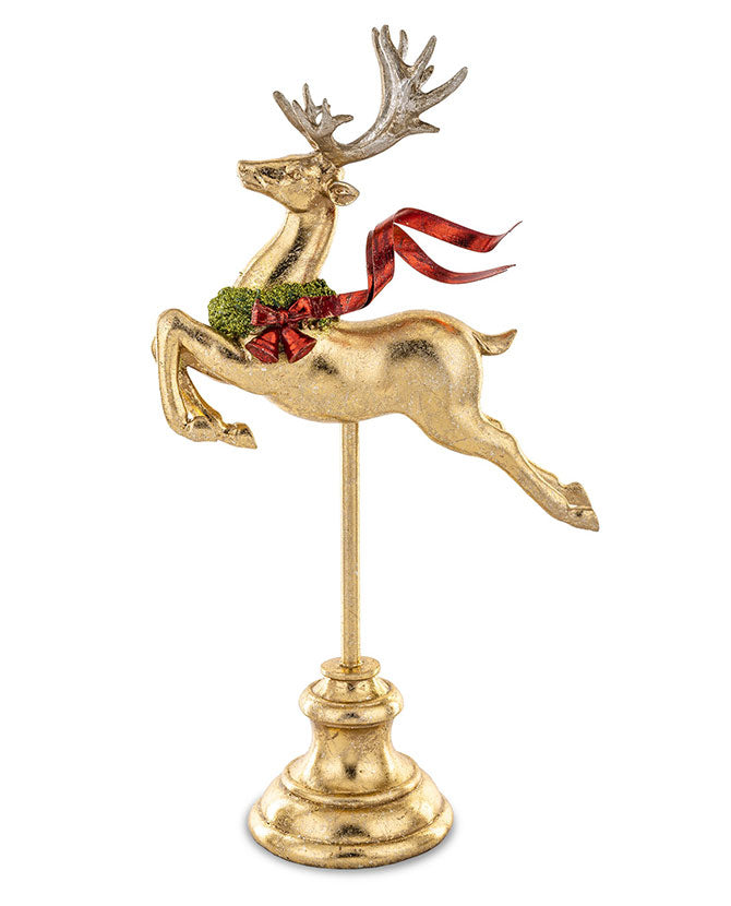 Piros színű fémmasnival díszített, fényes felületű, arany színű karácsonyi szarvas figura.