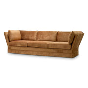 Rézszínű bársonyszövettel kárpitozott, modern stílusú exkluzív kanapé.