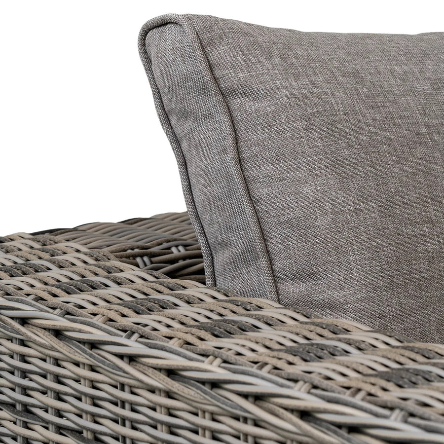 Közeli fotó a fonott műrattan karfáról és háttámláról.