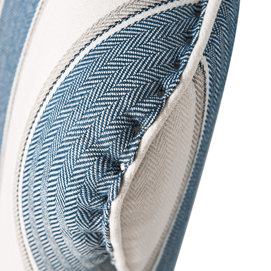 Kék és fehér csíkos szövettel kárpitozott, kézműves füles fotel.