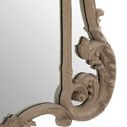 Barokk stílusú, antikolt felületű, szürkésbarna színű, fahatású díszes falitükör.