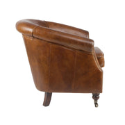 Vintage stílusú bőrfotel oldalnézetből, elegáns lekerekített háttámlával