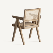 A karosszék hátulról és oldalról fotózva, jól látható a rattan háttámla és a fa szerkezet elegáns részletei.