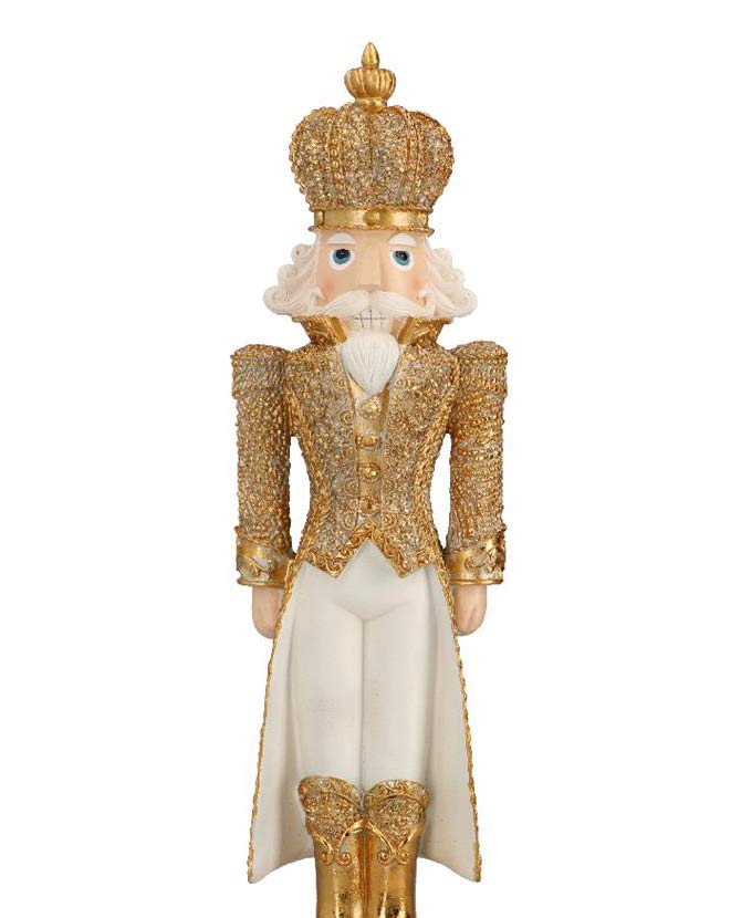 Gazdagon díszített, fehér és aranyszínű, karácsonyi diótörő király figura.