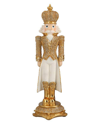 Gazdagon díszített, fehér és aranyszínű, karácsonyi diótörő király figura.