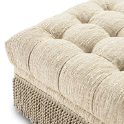 Krémszínű buklészövettel kárpitozott, ottomán.