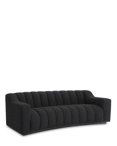 Fekete színű buklé szövettel kárpitozott dizájn kanapé.