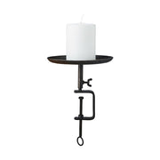 Fekete színű, vasból készült, kézműves gyertyatartó.