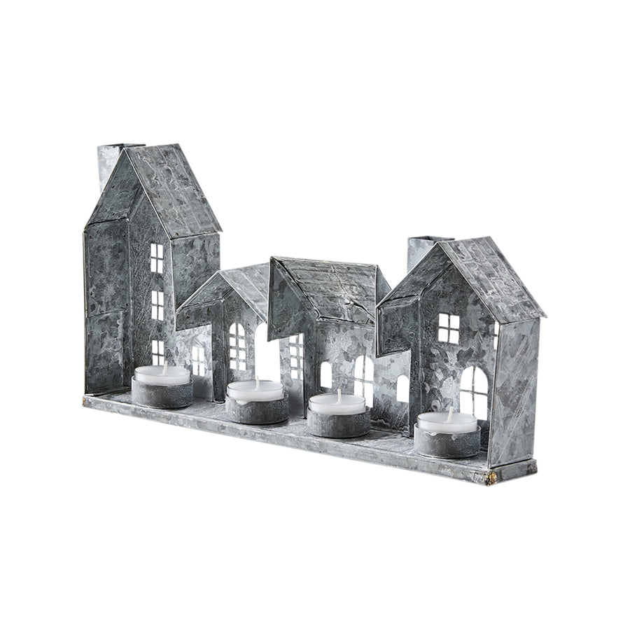 Szürke színű, bádogból készült házikókat formázó lámpás.