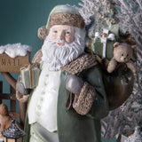 Vintage stílusú zöld Mikulás figura ajándékokkal és plüssmackóval
