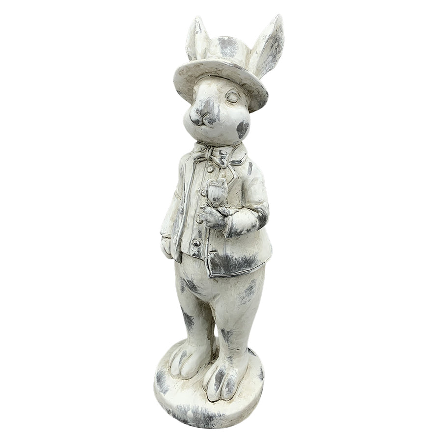 Antikolt felületű, krémszínű húsvéti nyuszifiú figura.