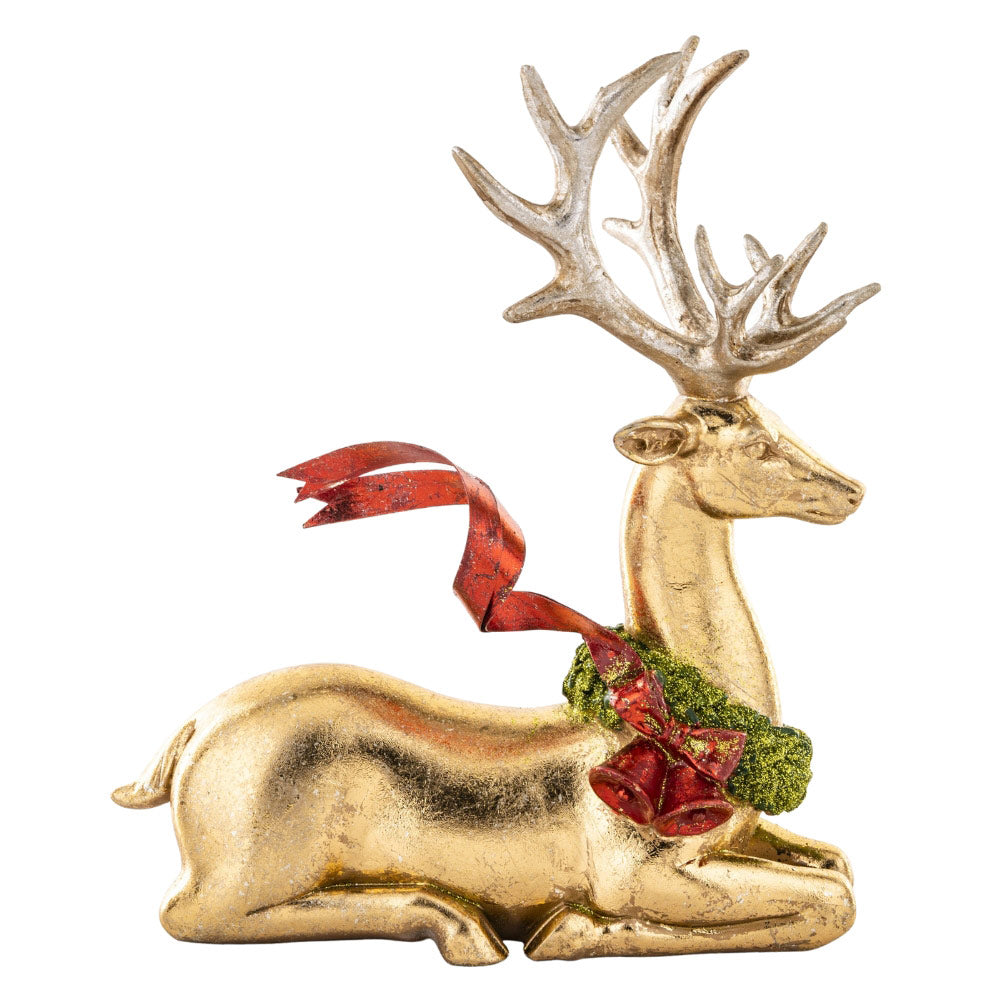 Piros színű fémmasnival díszített, fényes felületű, aranyszínű karácsonyi szarvas figura.