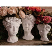 Antikolt felületű, krém színű kaspó büszt.