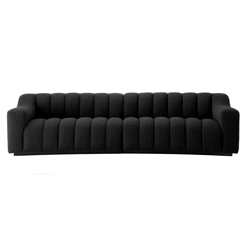 Art Deco ihletésű, modern kortárs stílusú, íves kialakítású fekete színű buklé szövettel kárpitozott óriás dizájn kanapé.