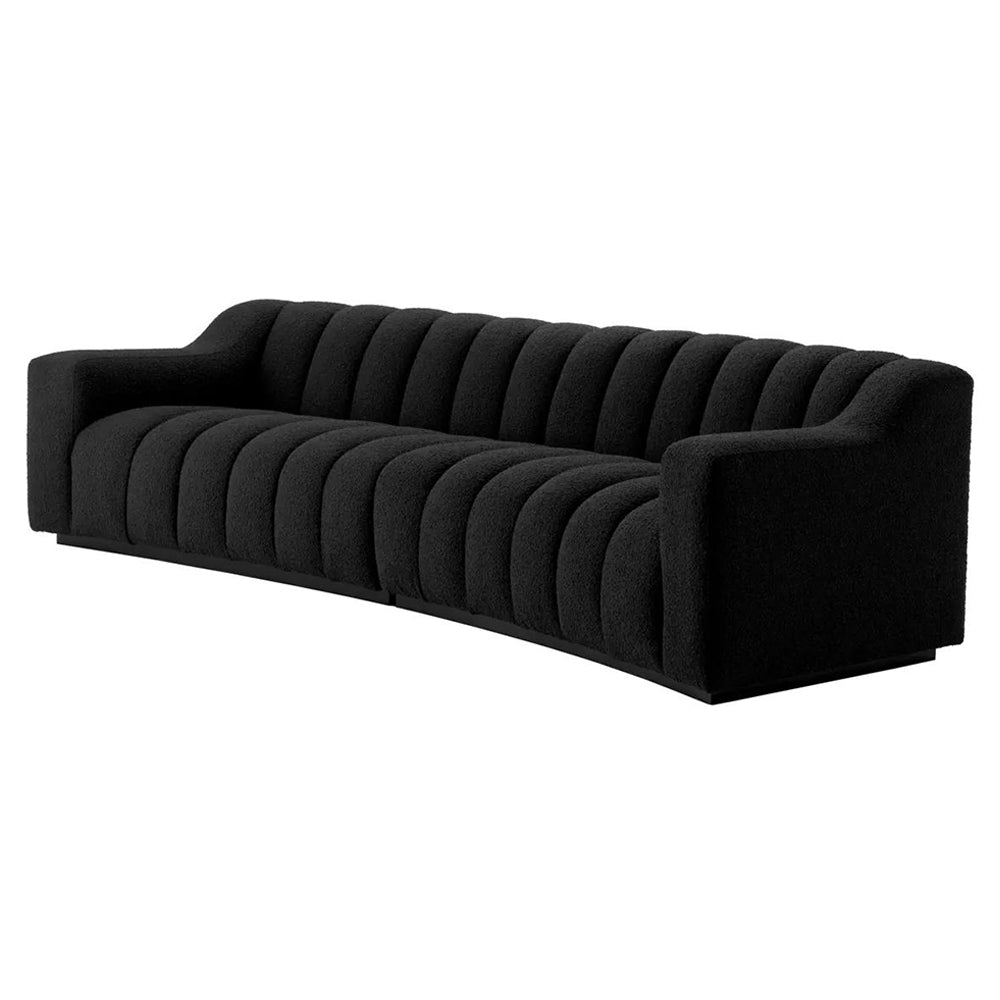 Art Deco ihletésű, modern kortárs stílusú, íves kialakítású fekete színű buklé szövettel kárpitozott óriás dizájn kanapé.
