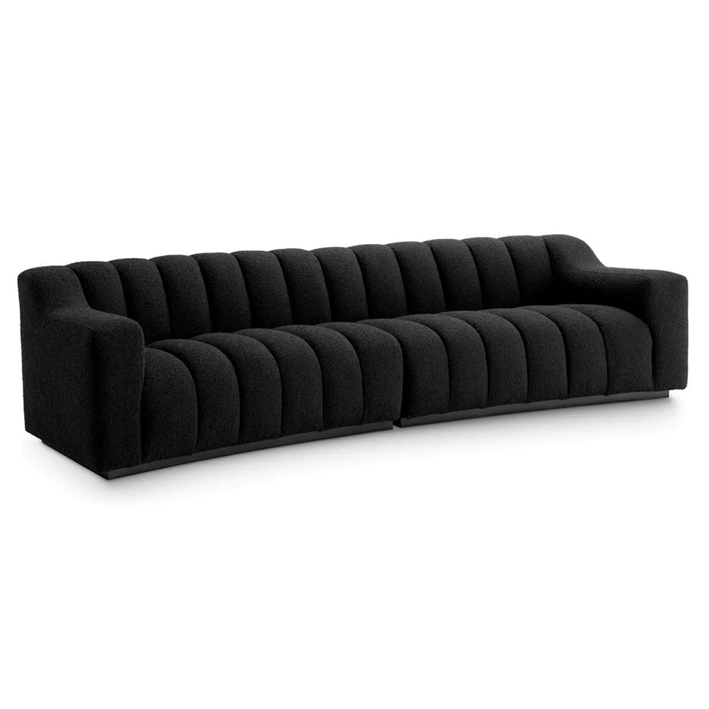Art Deco ihletésű, modern kortárs stílusú, íves kialakítású fekete színű buklé szövettel kárpitozott óriás dizájn kanapé.