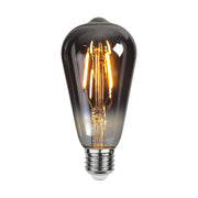 Füstszínű üvegből kialakított, dekorációs LED vintage izzó.