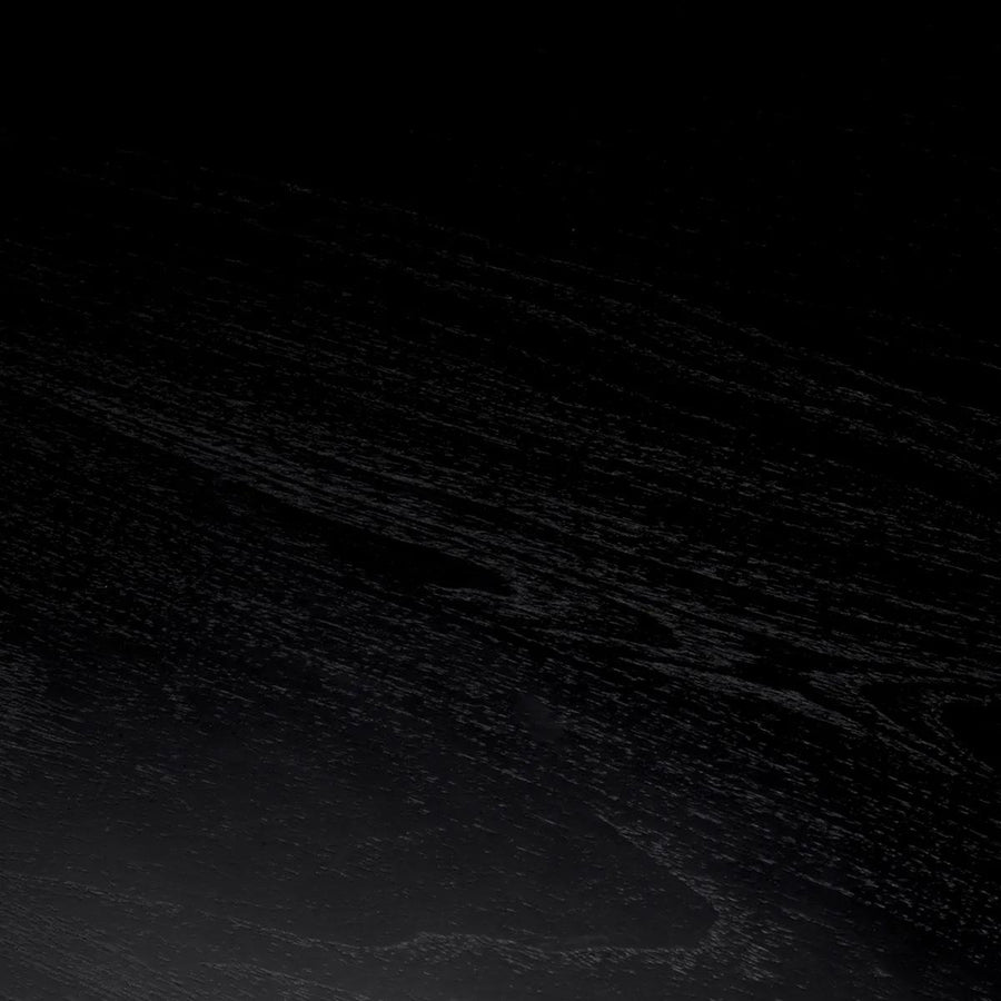 Fekete színű mindifa furnérból készült, formatervezett központi könyvtár asztal.