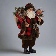 Ajándékot hozó, bordó színű Mikulás figura.