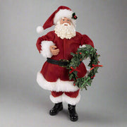 Koszorút tartó, piros színű Mikulás figura.