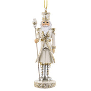 Krém és aranyszínű, diótörő figurás karácsonyfadísz.